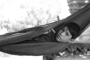 Portrait of a kid resting in a hammock in Battambang, Cambodia